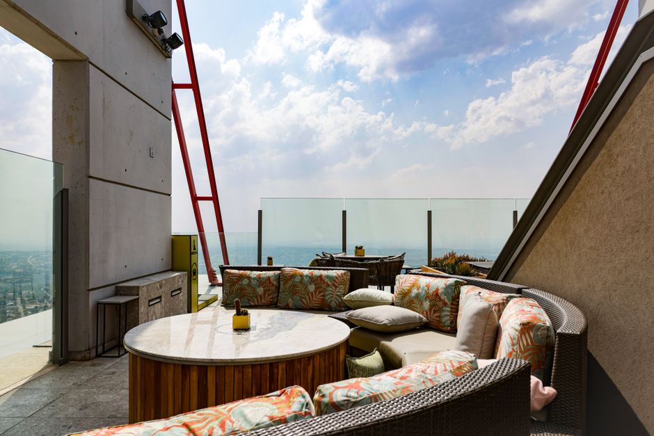 Rooftop lounge with panoramic city views and comfortable seating - urban luxury apartments Rooftop lounge with panoramic city views and comfortable seating - urban luxury apartments