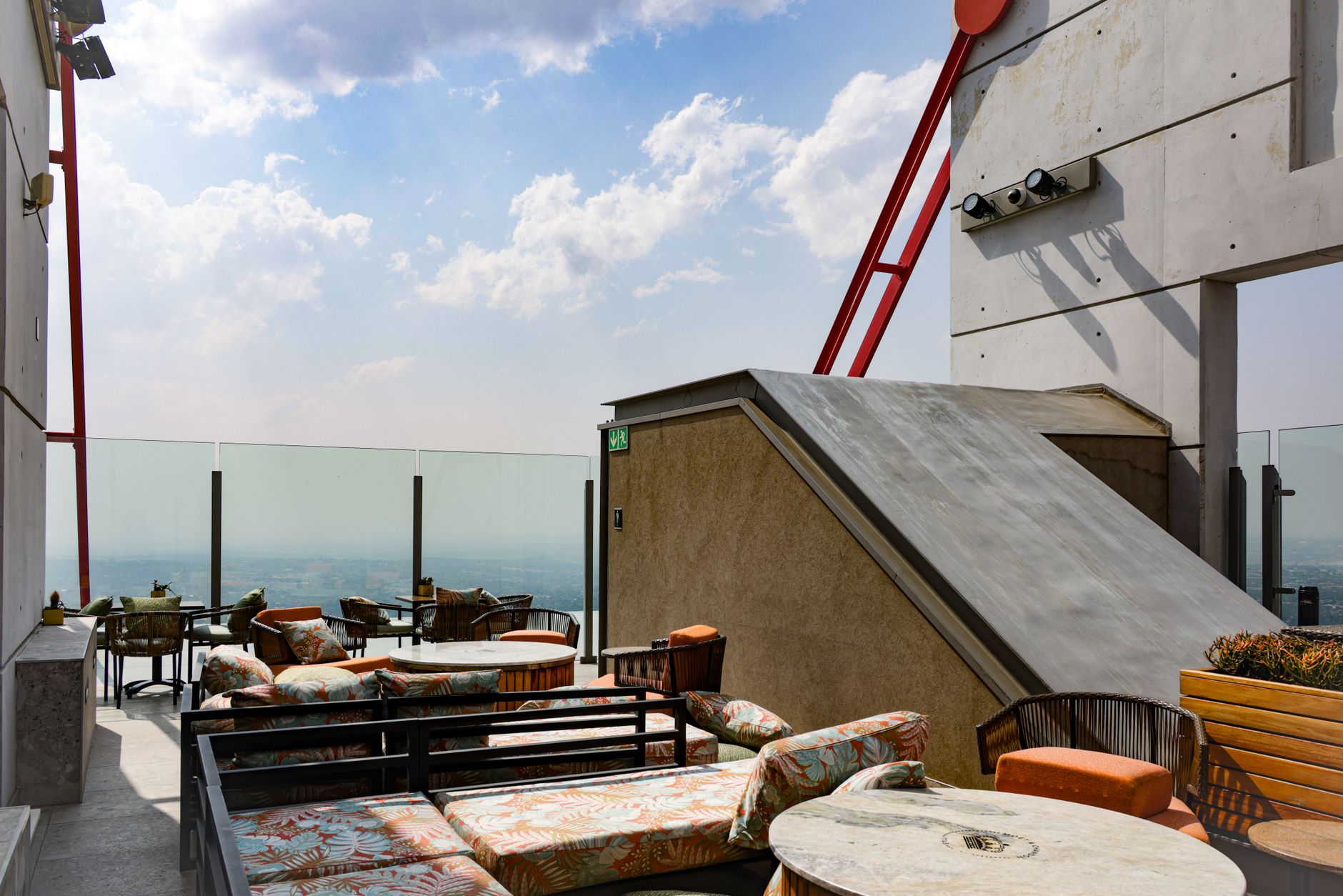 Relaxing rooftop lounge offering stunning cityscape views and modern outdoor seating.