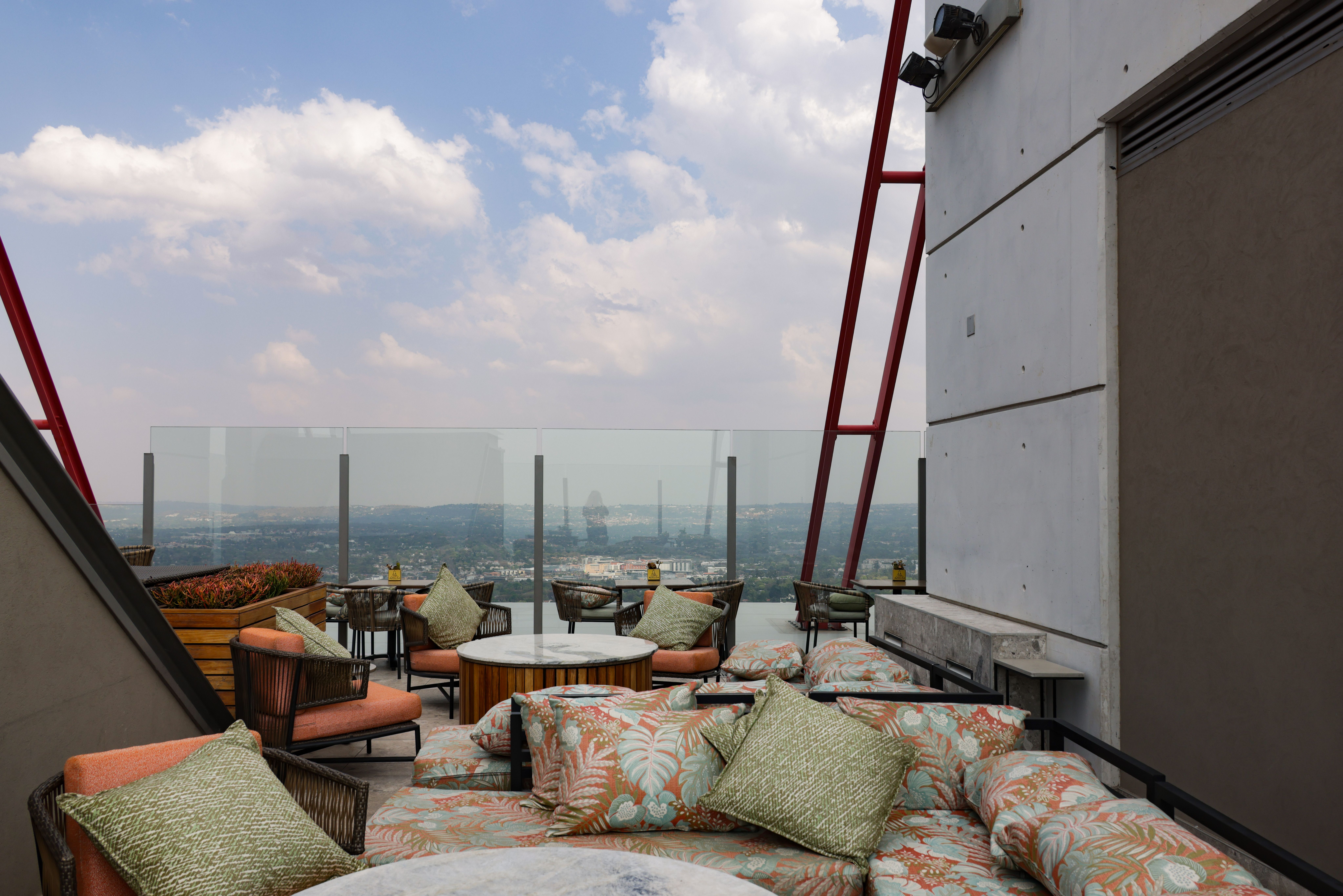 rooftop sky deck with luxury lounge seating and city skyline views - apartments with sauna