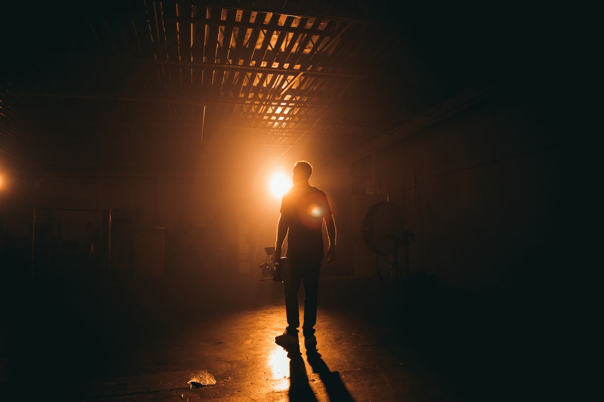 Cinematographer silhouetted on a dim set — photo by Kyle Loftus on Pexels