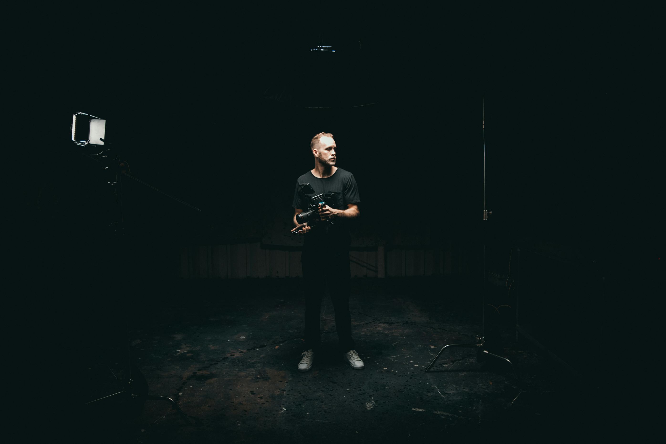 man standing in the middle of a dark room