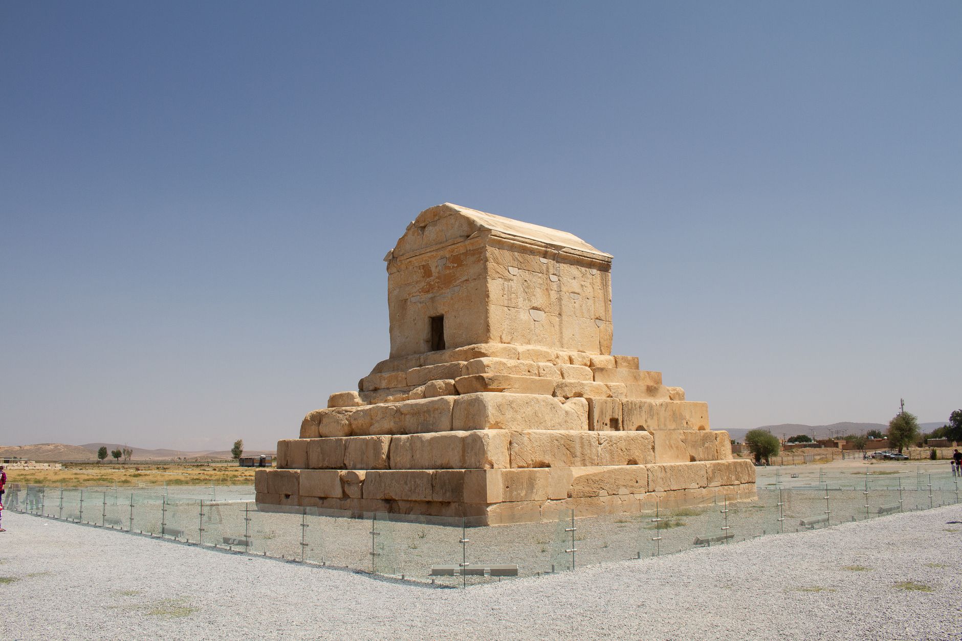 Stone tomb structure of Cyrus the Great in Pasargadae under clear sky.