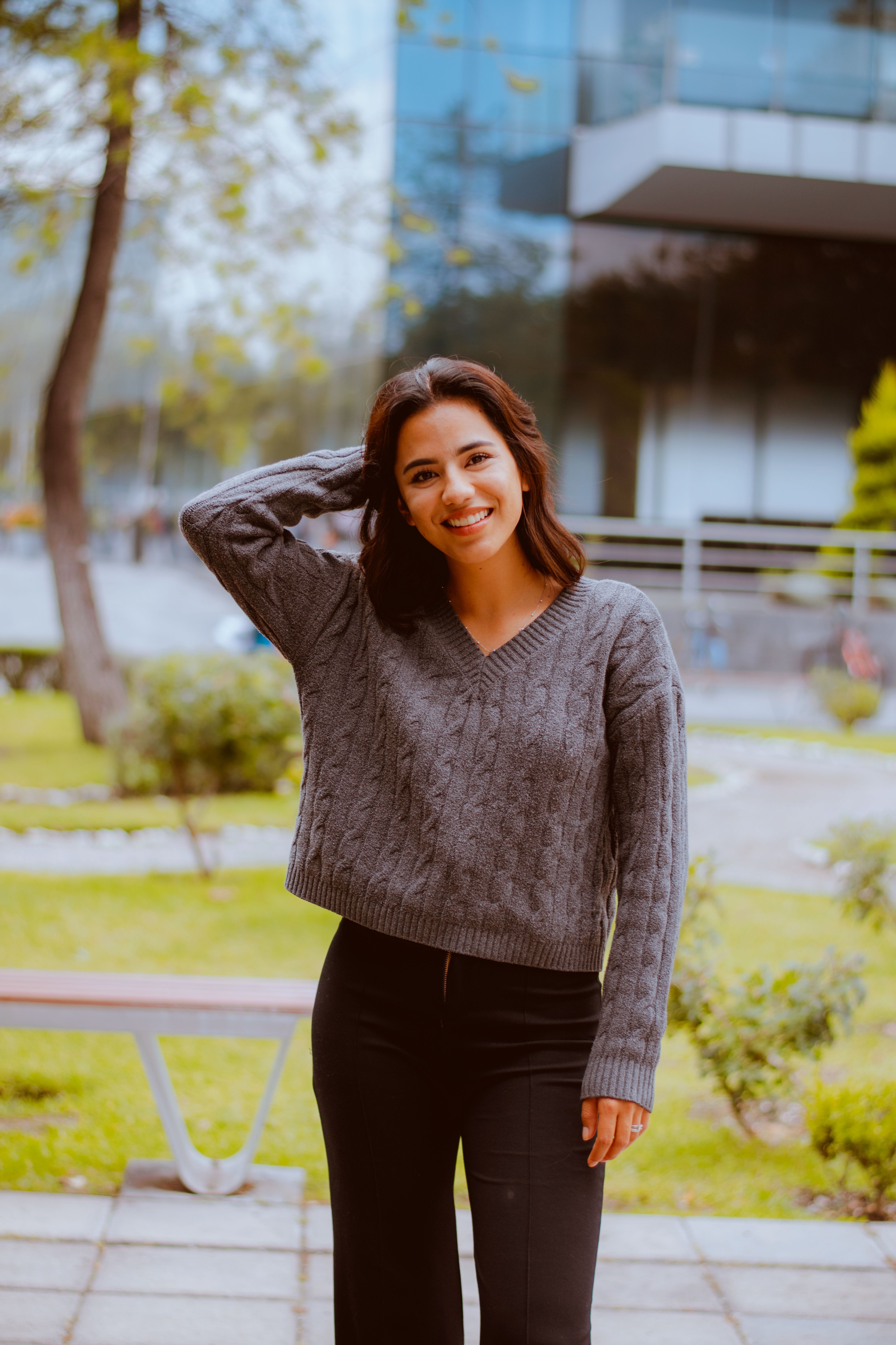 Smiling Woman in Urban Park Setting · Free Stock Photo