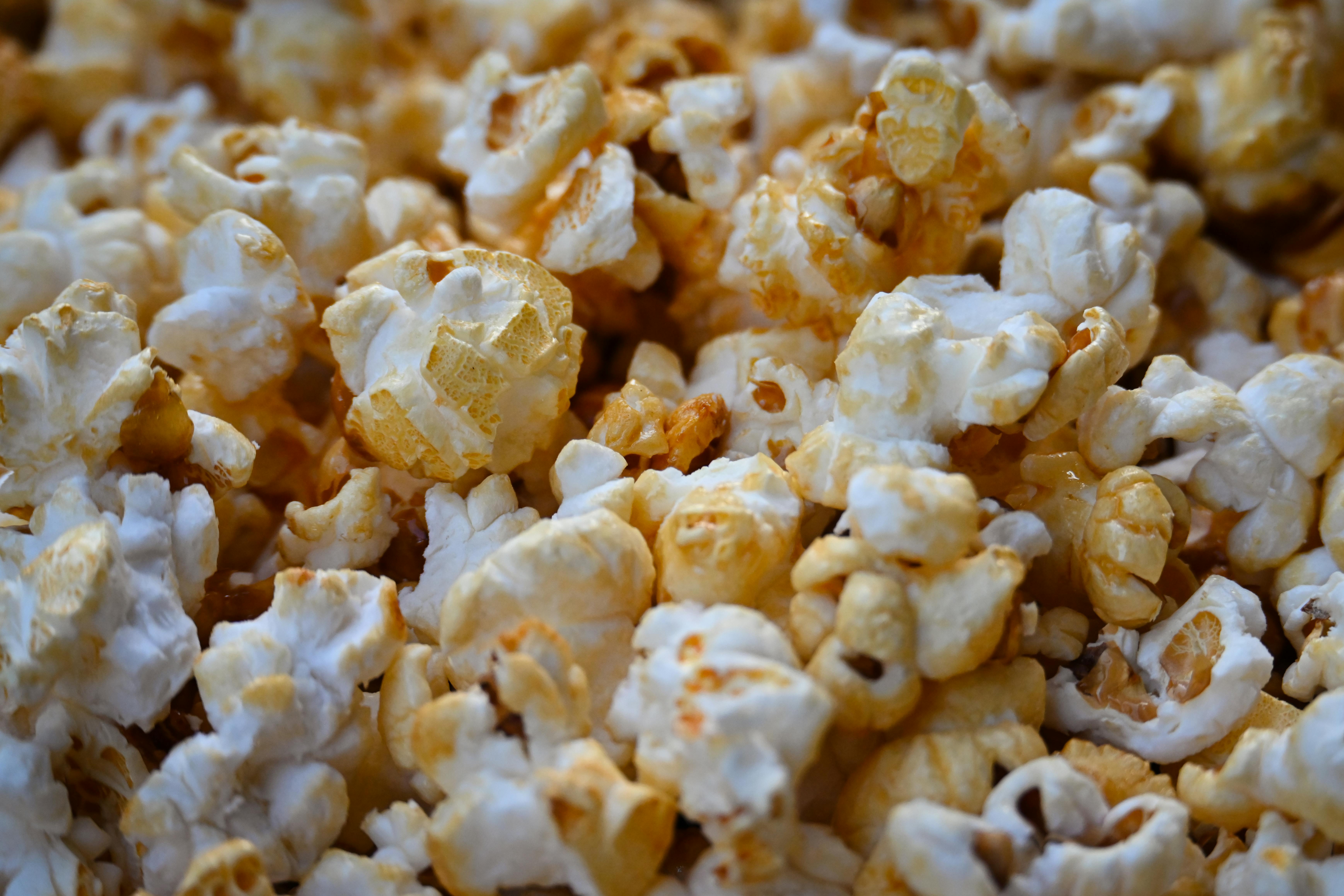 Tasty buttered popcorn close-up view, ideal snack for movie night.