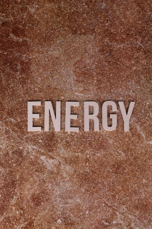 Free Stylish depiction of the word 'ENERGY' on a brown textured surface. Stock Photo