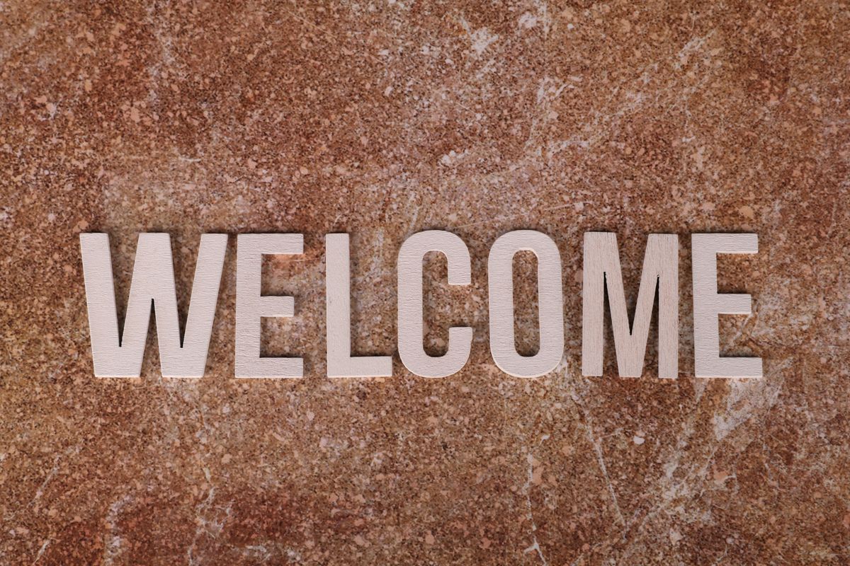 A textured welcome sign