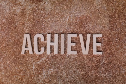 Wooden letters spelling 'ACHIEVE' on a textured brown surface, conveying motivation and success.