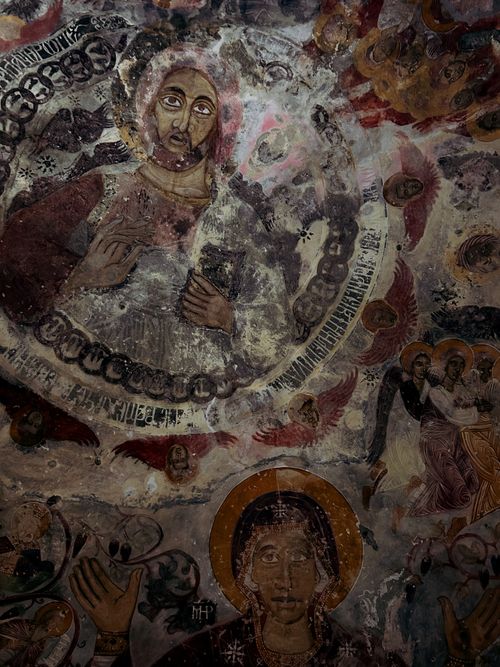 Free Intricate ancient fresco depicting religious iconography and celestial motifs. Stock Photo