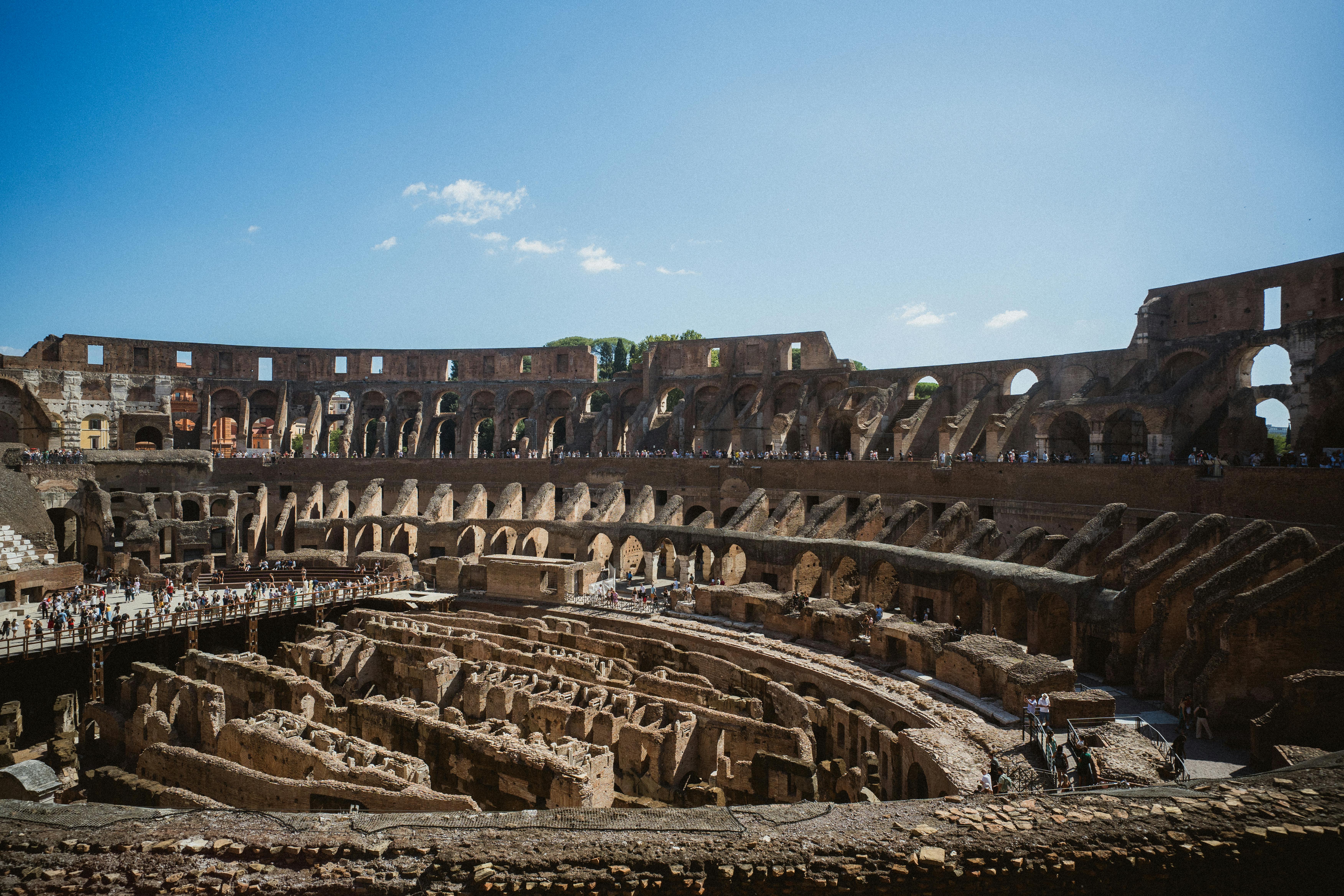 Iconic Colosseum in Rome under clear blue sky — 80 AD completed, 50,000-capacity gladiator amphitheater