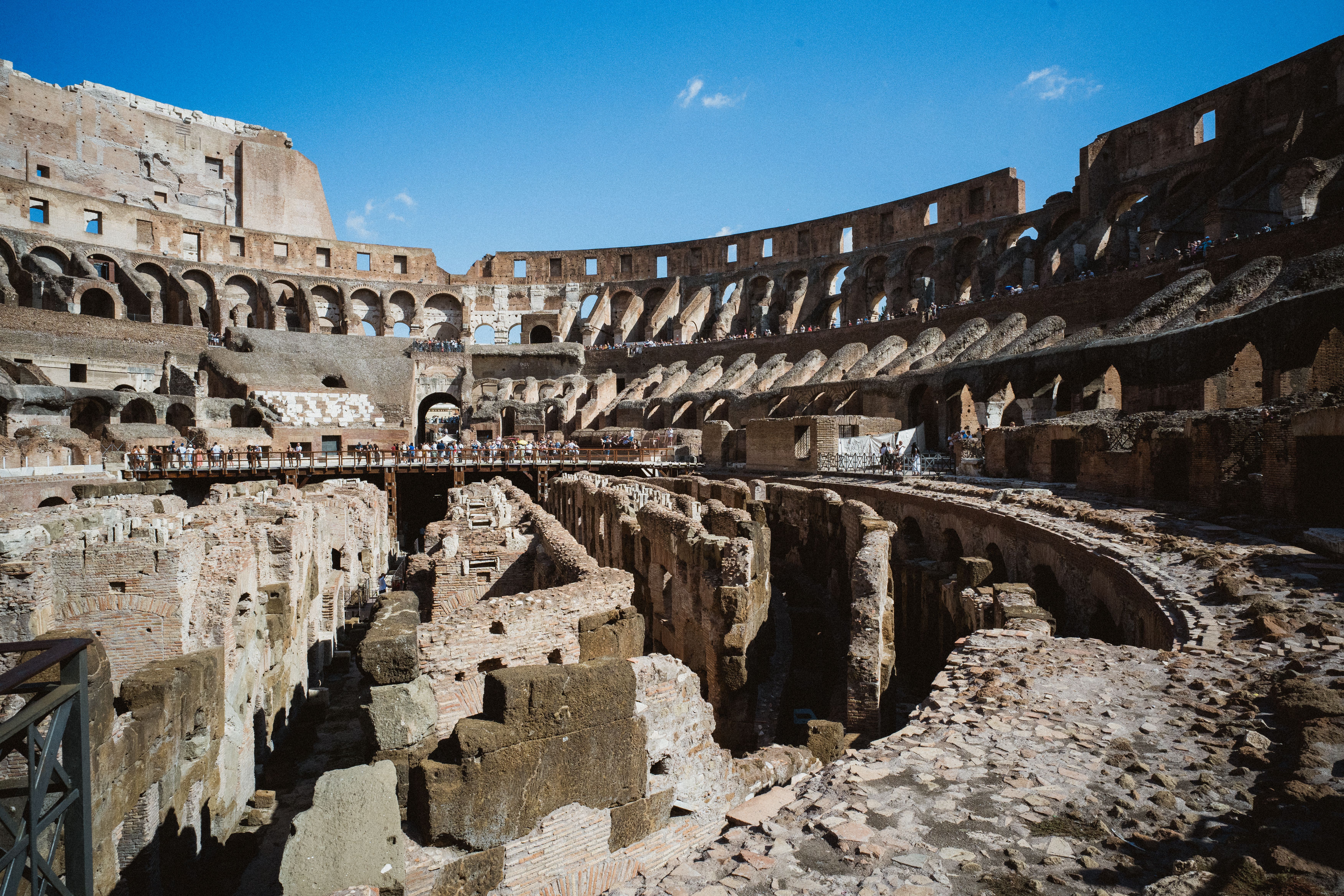 Tourists enjoying a hot summer day near the Colosseum in Rome, Italy, with clear skies