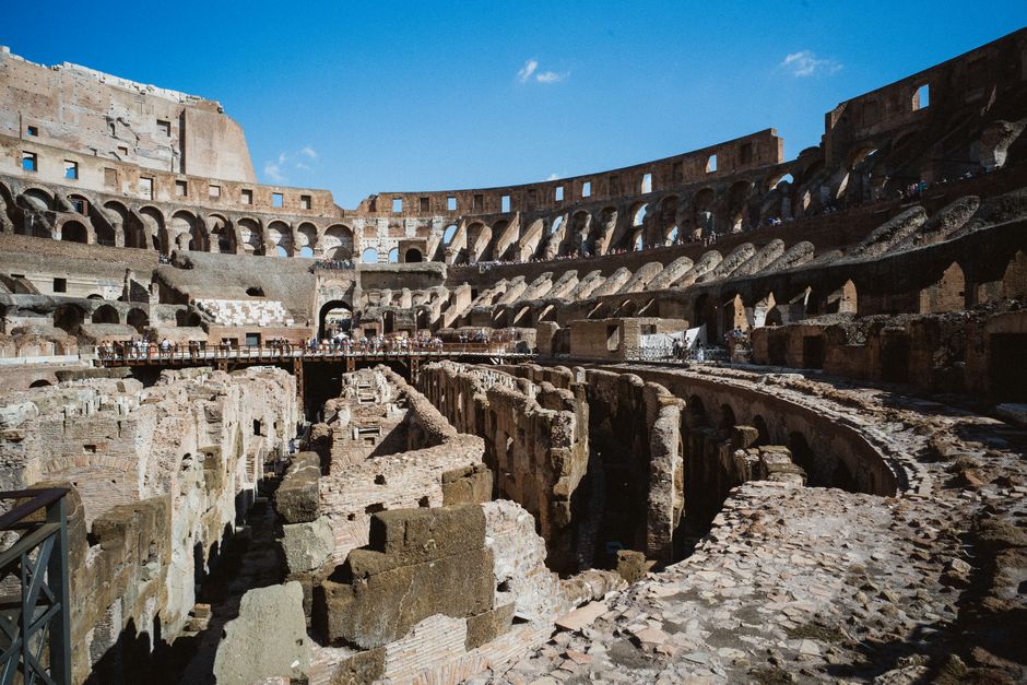 Tourists enjoying a hot summer day near the Colosseum in Rome, Italy, with clear skies