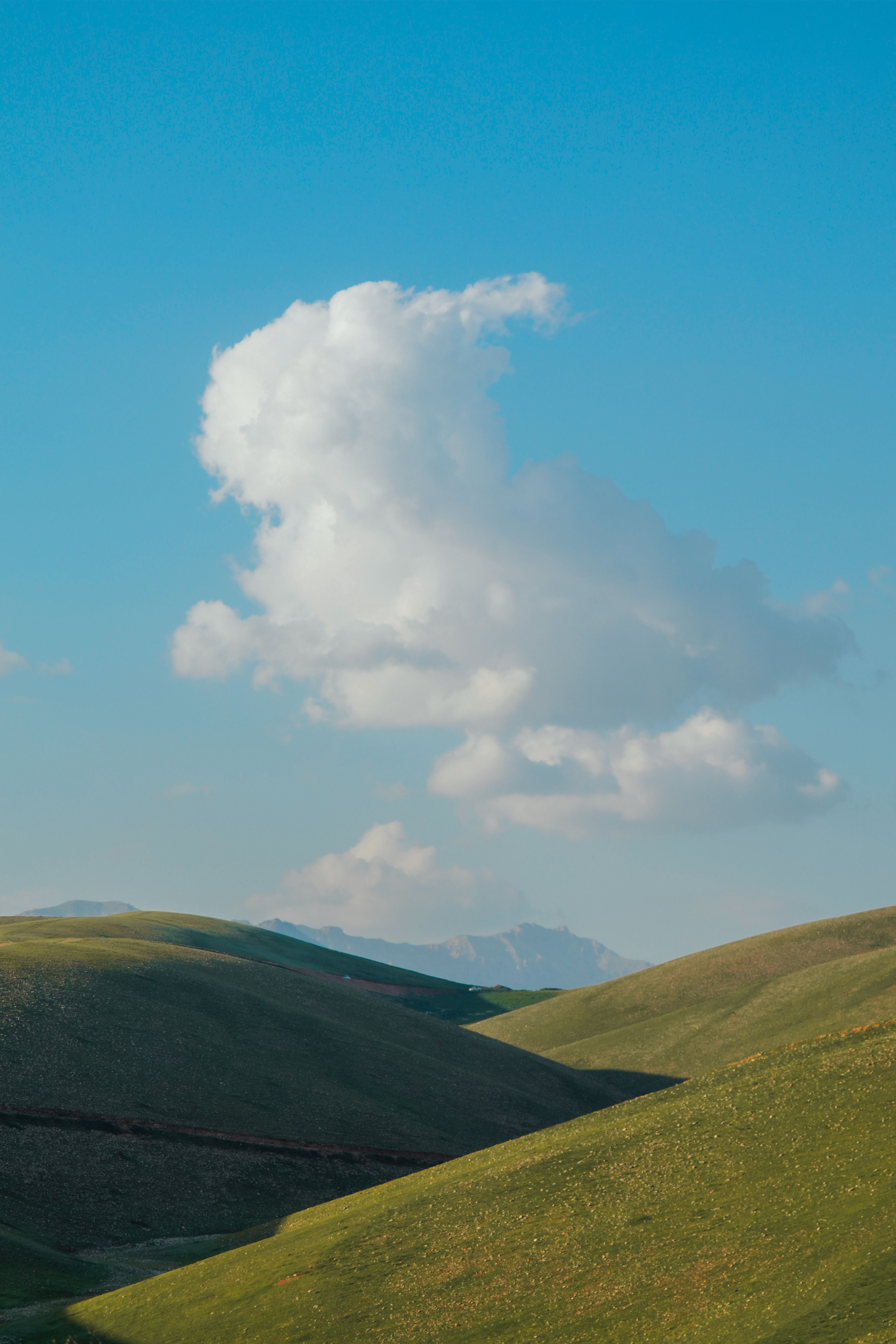 Scenic Rolling Hills Under Clear Blue Sky · Free Stock Photo