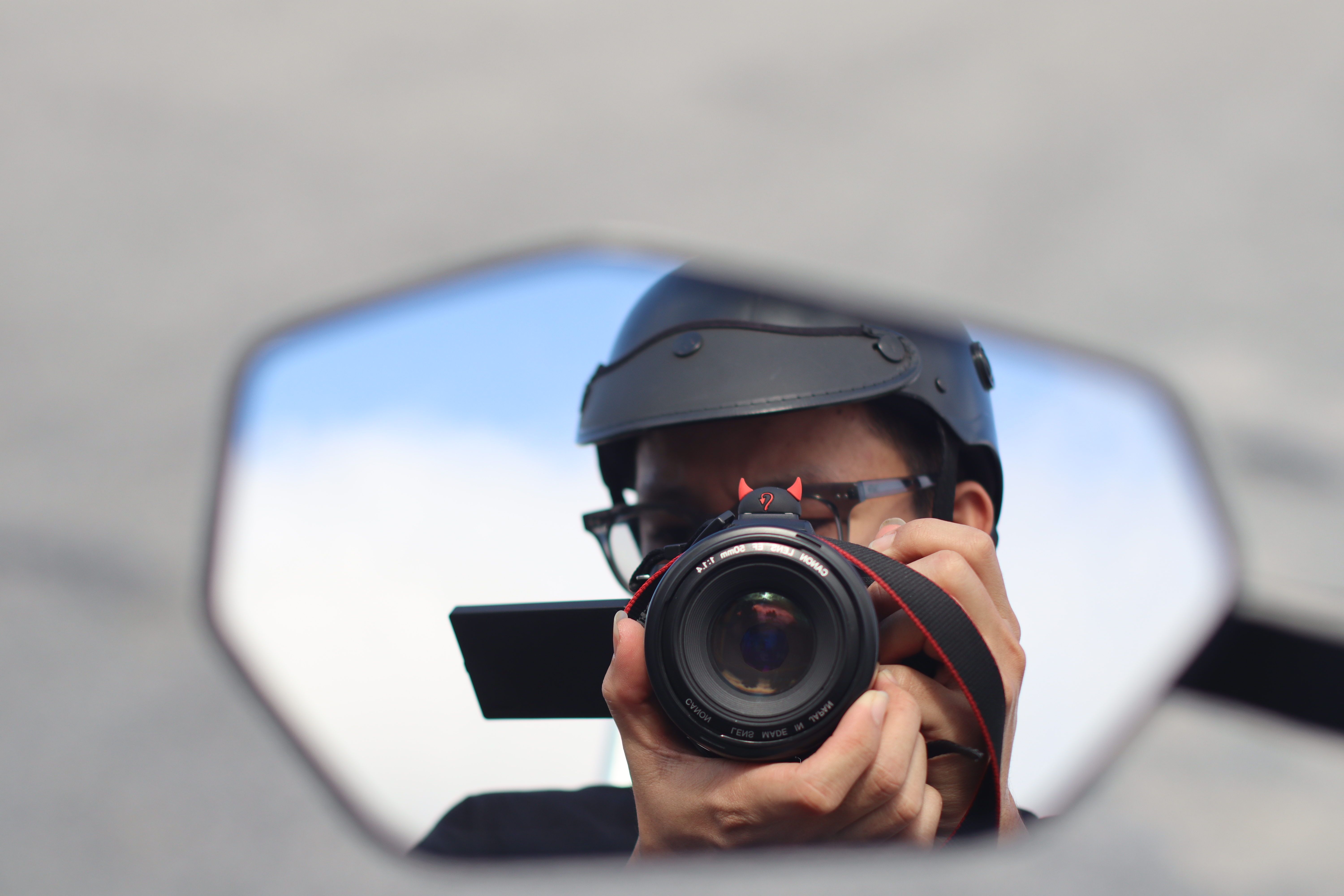 Photographer's Reflection in a Helmet Mirror · Free Stock Photo