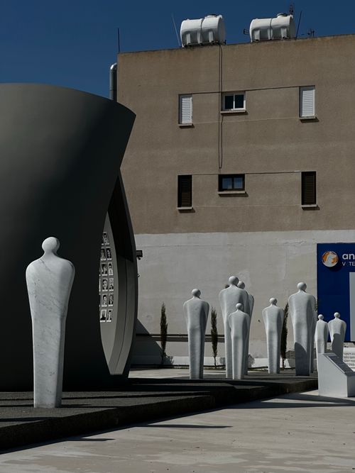 Free Contemporary figurative sculptures in an urban outdoor setting against a building backdrop. Stock Photo