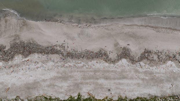 Drone shot of ocean pollution along a beach in Panama City, showcasing environmental impact.