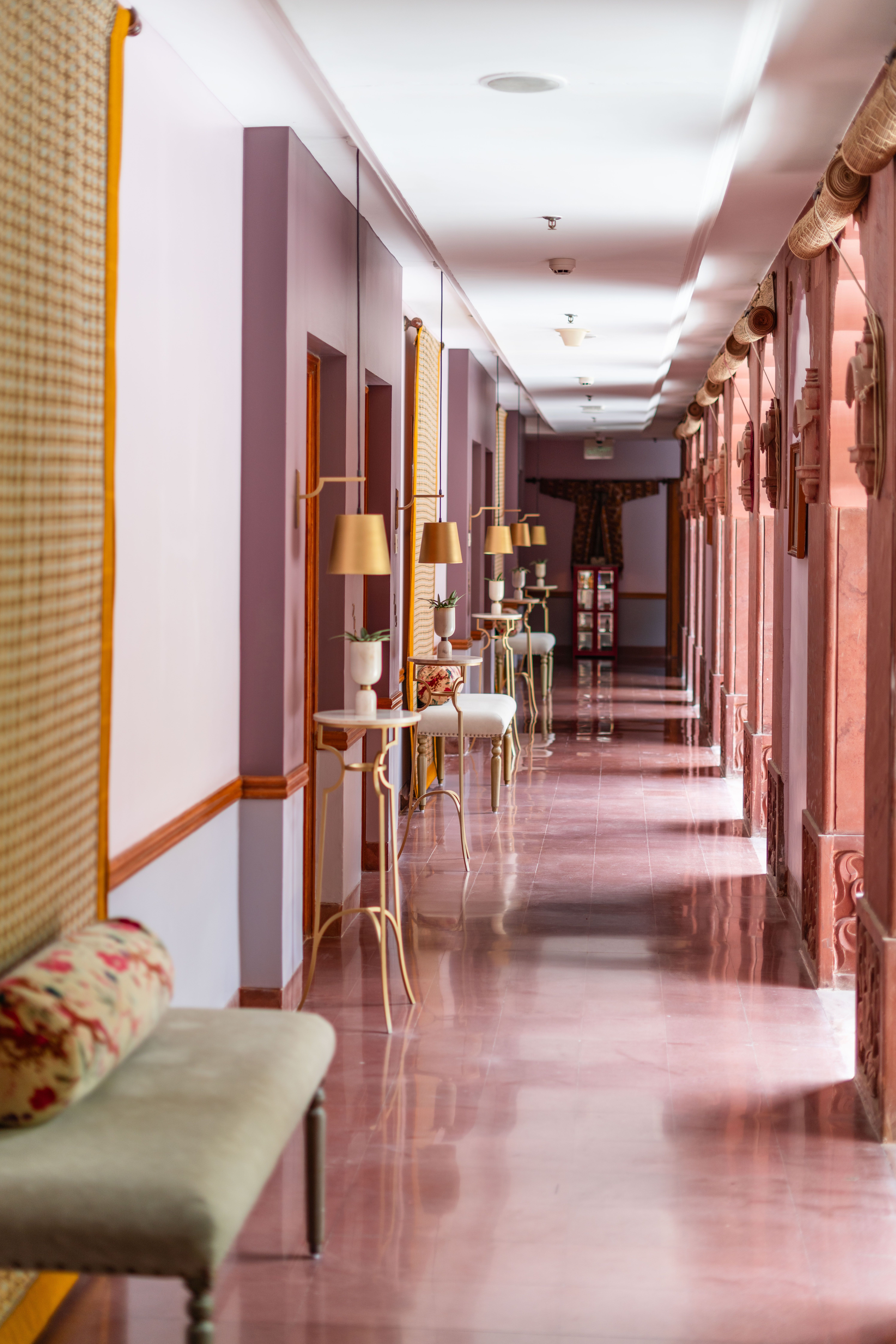 Elegant heritage hotel corridor with chandelier and arched ceiling