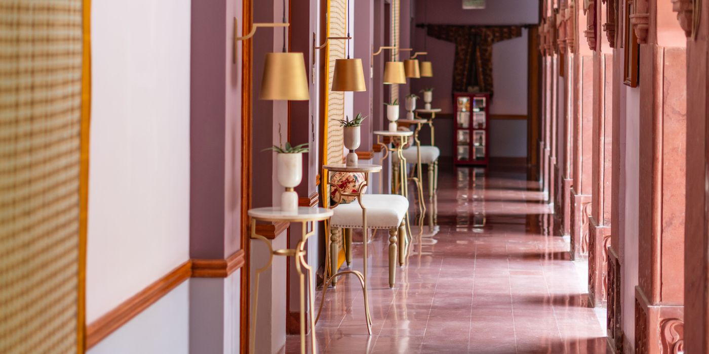Elegant heritage hotel corridor with chandelier and arched ceiling