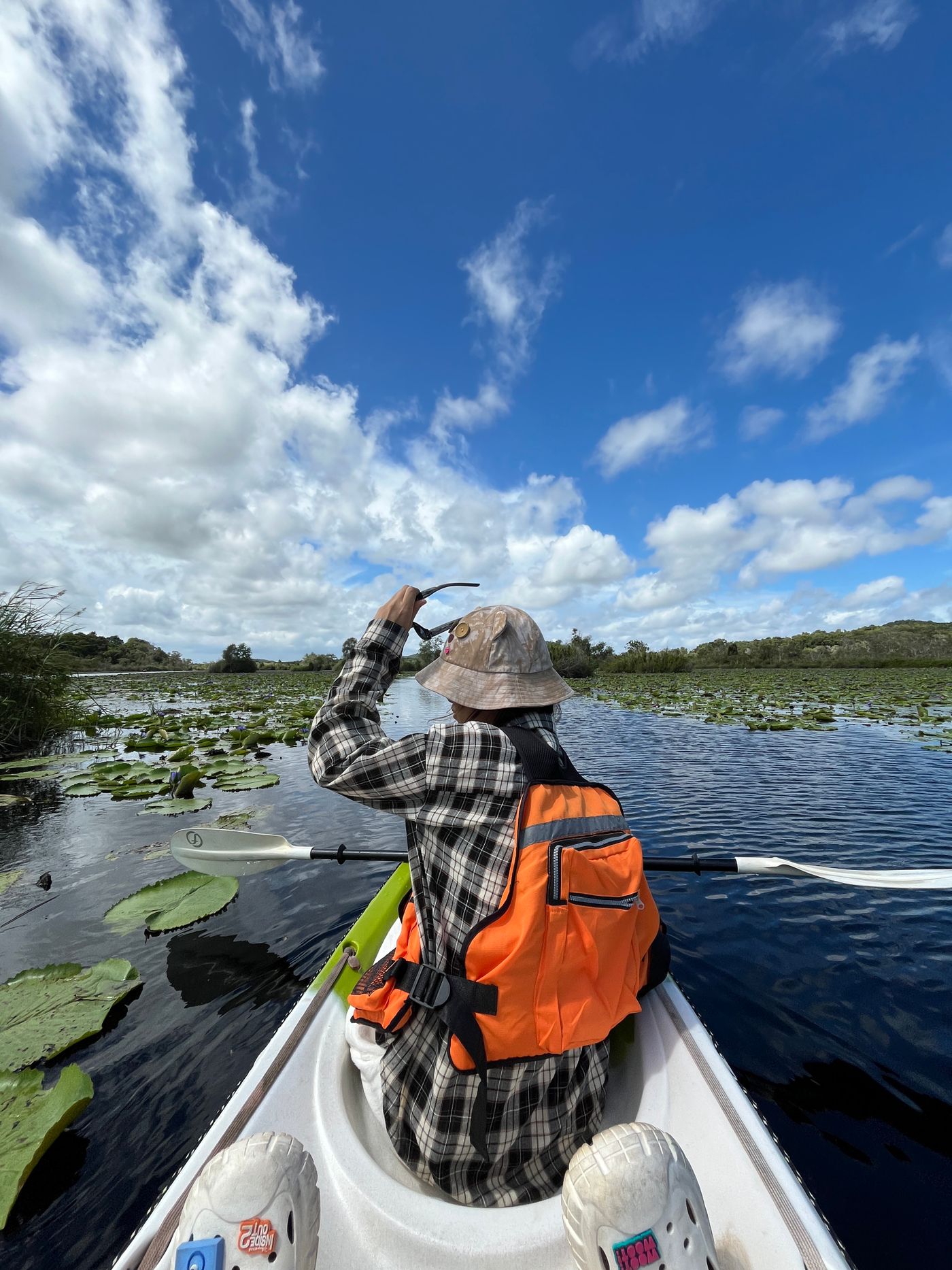 Kayaker exploring a peaceful lake surrounded by nature