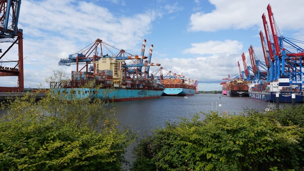 Large container ships docked at Hamburg port under a clear blue sky, showcasing global trade.