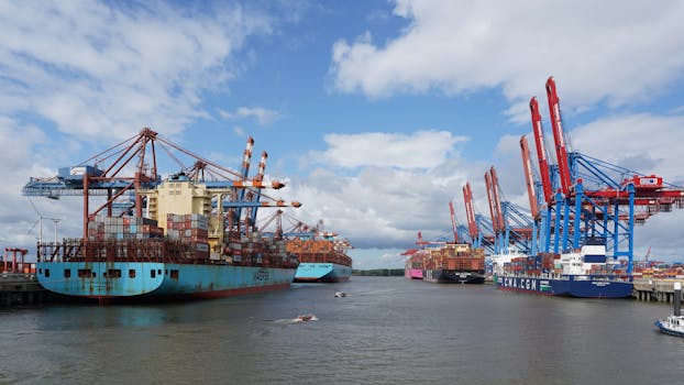 A vibrant view of container ships at Hamburg Port under a blue sky.