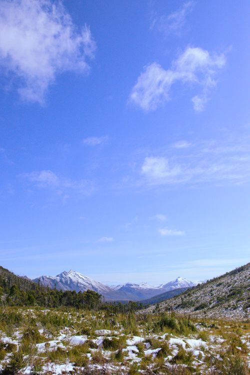 Free Explore the serene snow-capped mountains of Southwest Tasmania with clear blue skies. Stock Photo