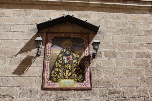 Free Beautiful religious artwork displayed on a stone wall in Jerez de la Frontera, Spain. Stock Photo