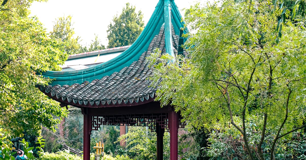 A serene oriental pavilion surrounded by lush greenery in a peaceful garden scene.
