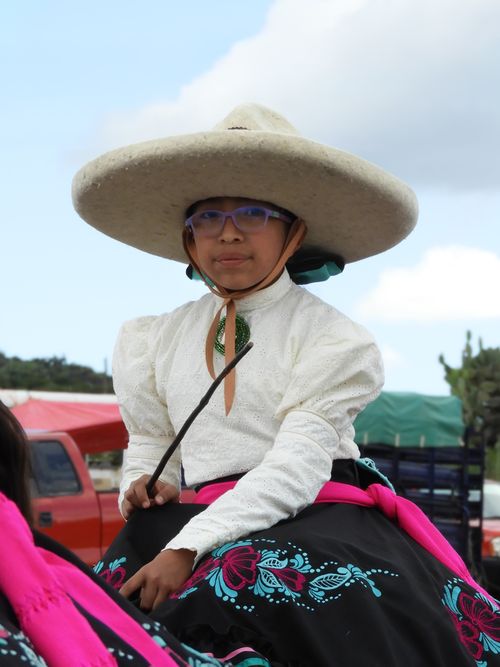 Free Boy in traditional charro costume riding a horse during an event in Hidalgo, Mexico. Stock Photo