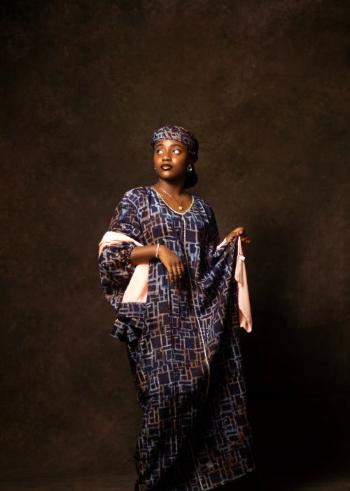 Free A stunning portrait of a woman wearing traditional patterned attire and headwrap Stock Photo