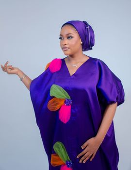 Portrait of a woman in a colorful traditional dress with graceful demeanor.