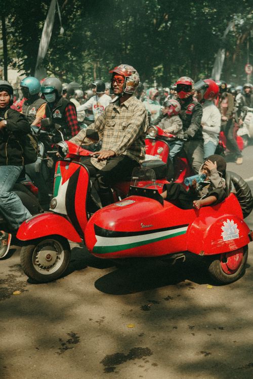 Free Vibrant scooter parade in Bandung, Indonesia, showcasing classic Vespa culture and community spirit. Stock Photo