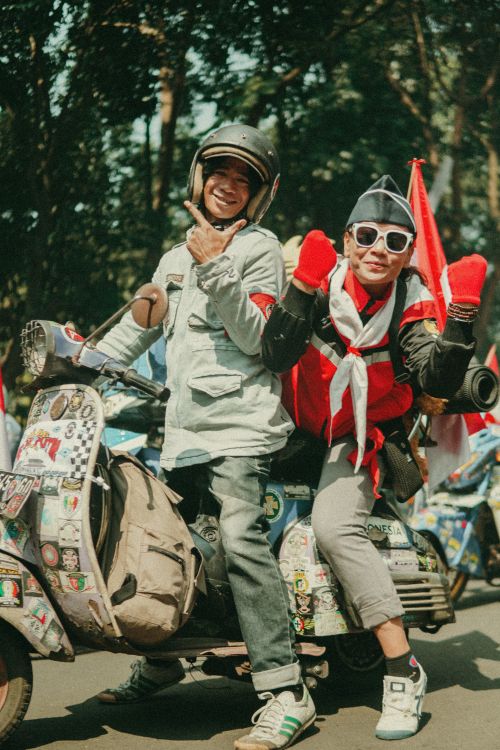 Free Cheerful riders celebrate Indonesia Independence Day with a vintage scooter parade in Bandung. Stock Photo