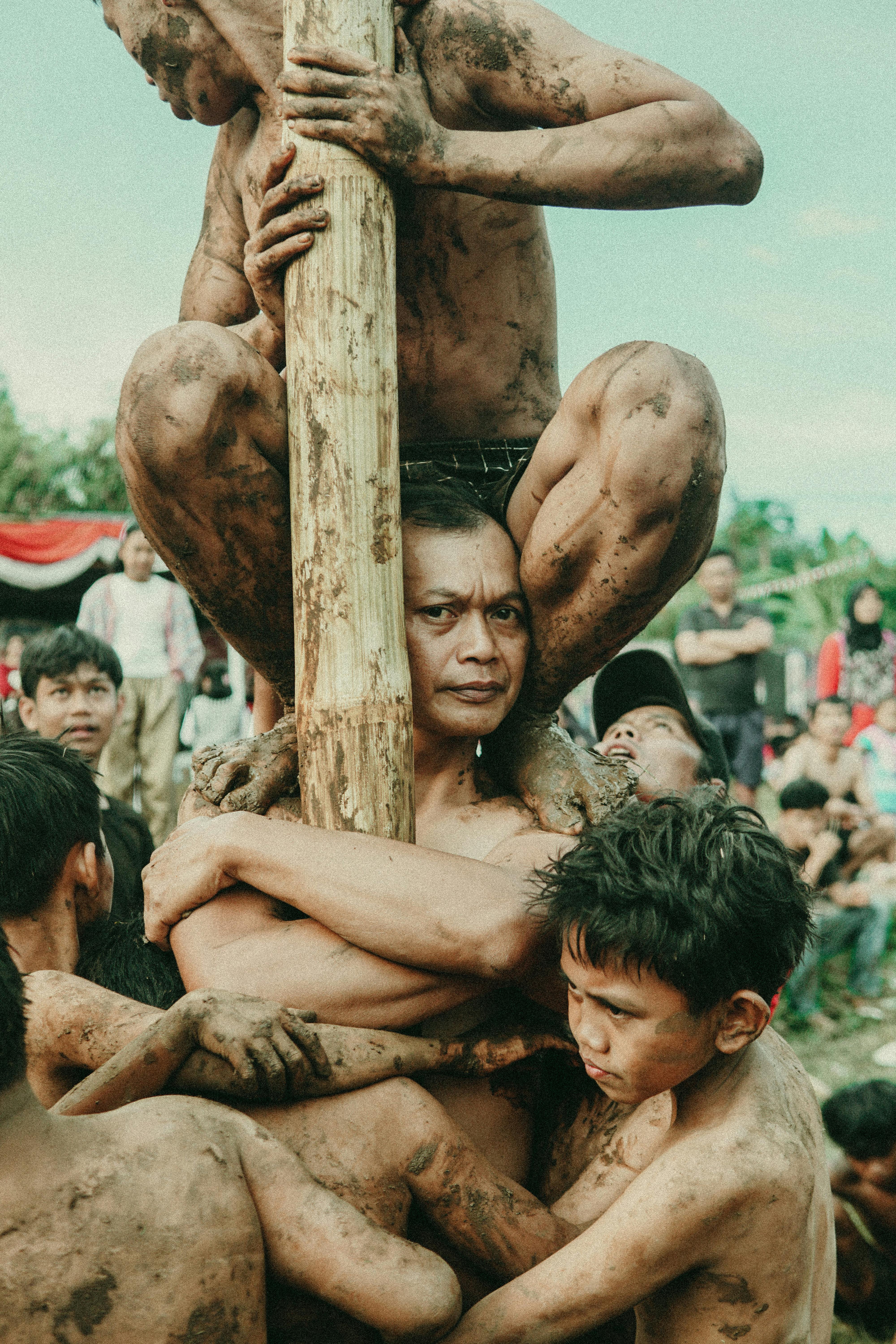 Participants climbing a greased pole during the Panjat Pinang game in Bandung, Indonesia.