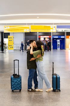 Couple sharing a tender moment at São Paulo airport with luggage, showcasing travel and love.
