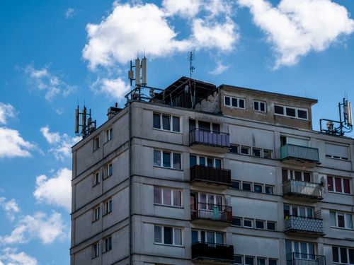 Free High-rise apartment building with antennas and balconies under a sunny sky. Stock Photo