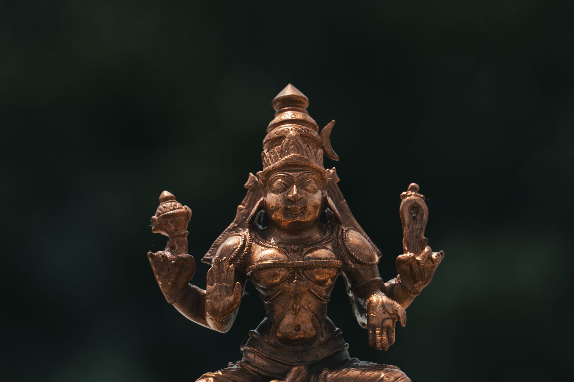 Hindu Deity Copper Statue in Close Up Photography