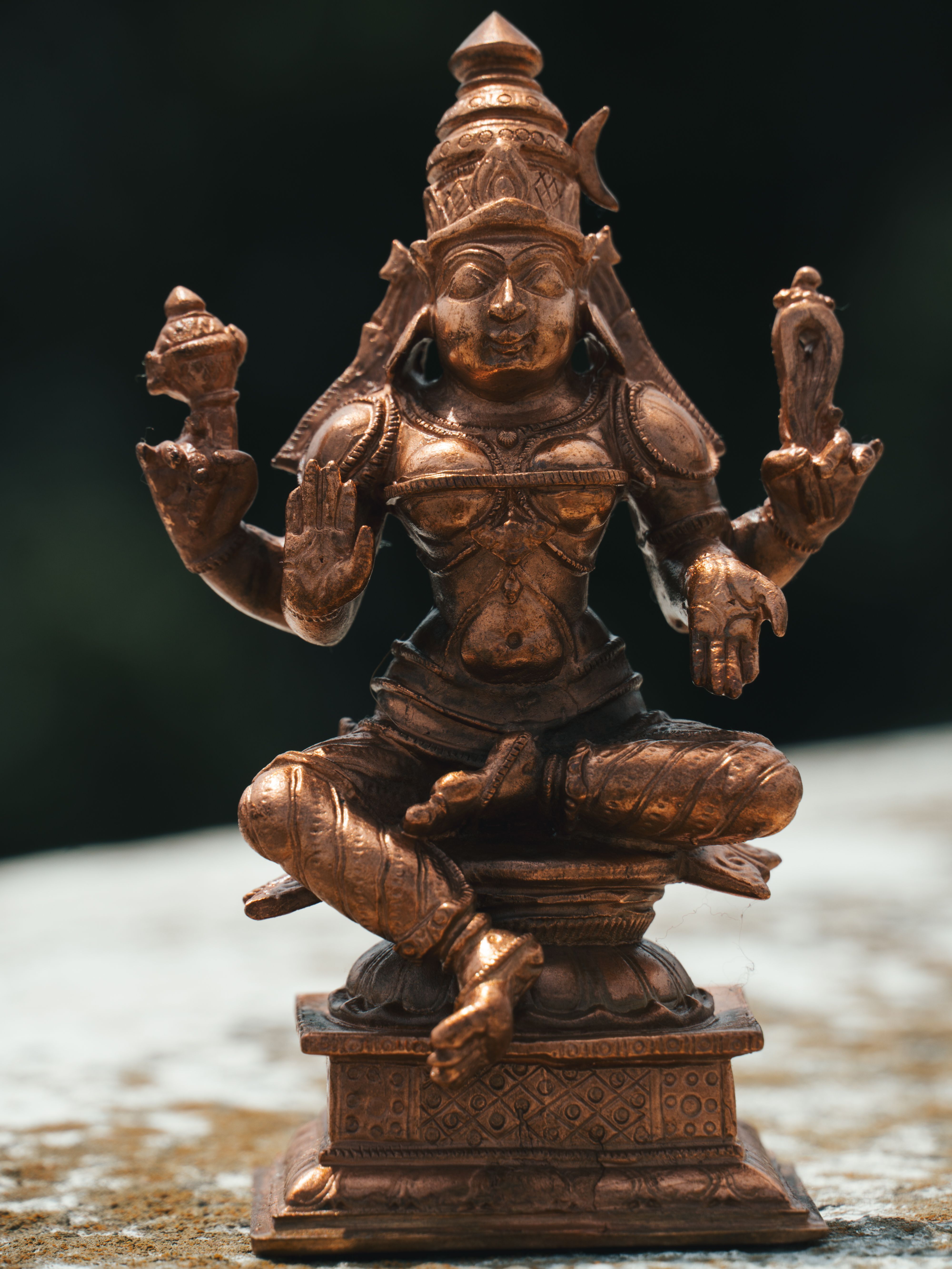 A detailed bronze statue of a Hindu deity, showcasing intricate artistry, captured in Bangalore, India.