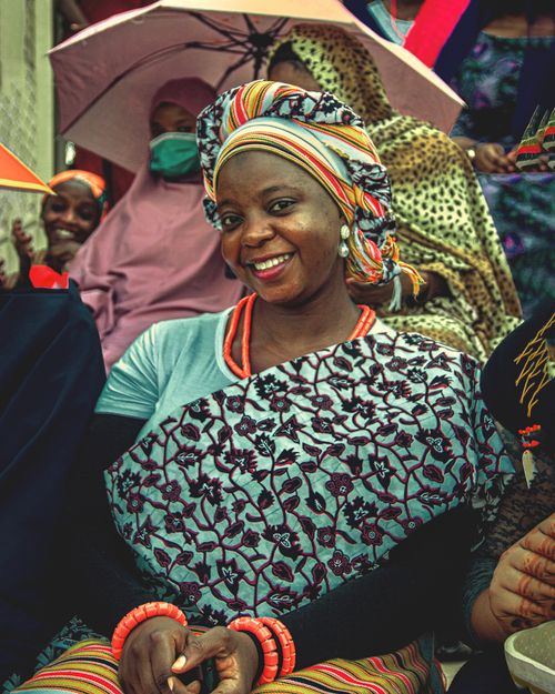 Free A joyful gathering of adults dressed in colorful cultural attire, highlighting diversity and tradition. Stock Photo
