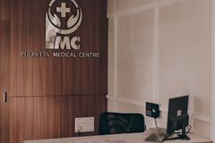 Warm and inviting medical center reception showcasing contemporary design with wood panel accents.