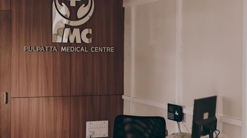 Warm and inviting medical center reception showcasing contemporary design with wood panel accents.