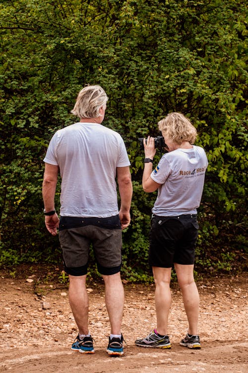 Man in White T-shirt and Black Shorts Looking at Woman in White T-shirt