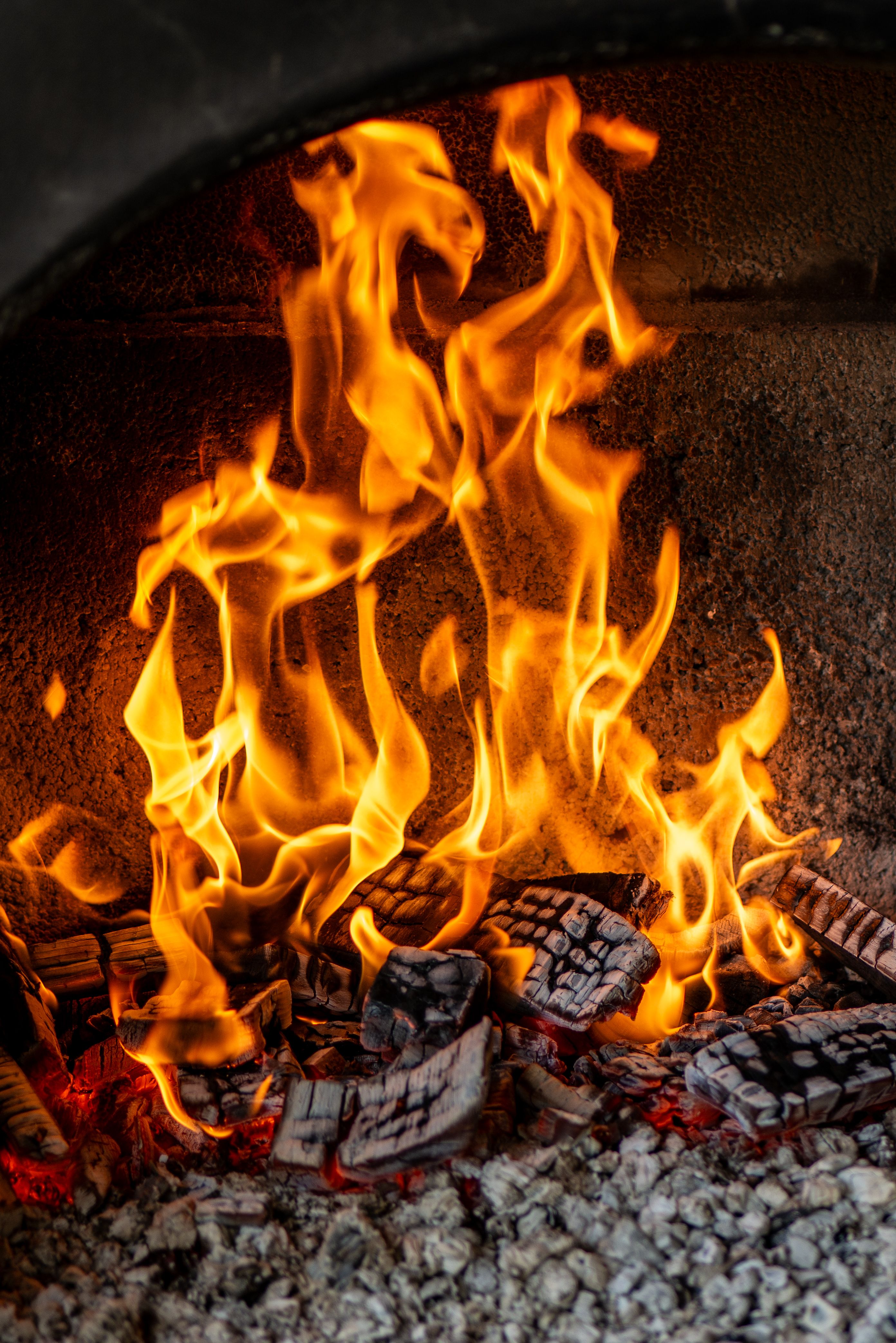 Bright orange flames dancing in a stone fireplace, creating a warm and cozy ambiance.
