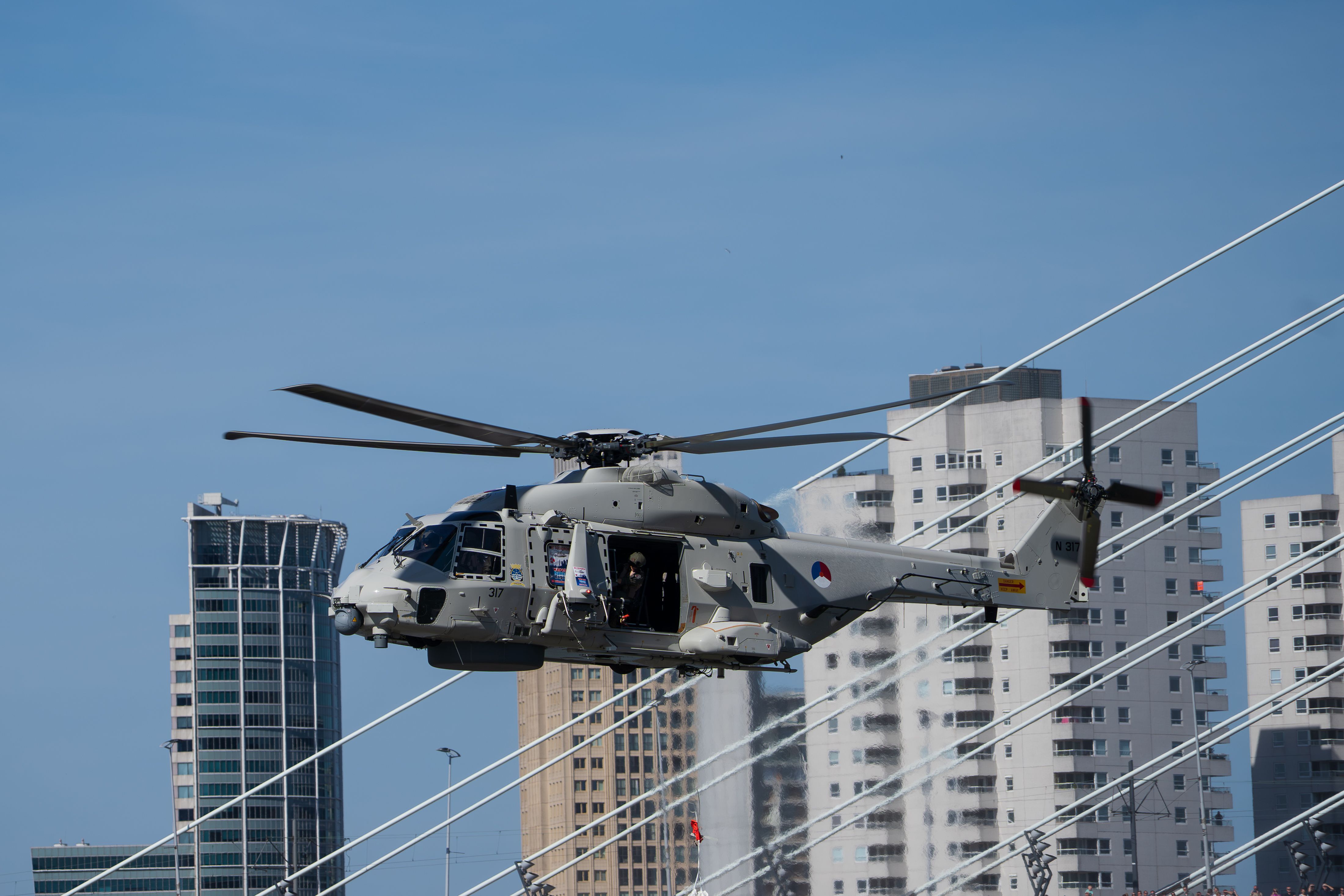 Military Helicopter Flying Near Skyscrapers