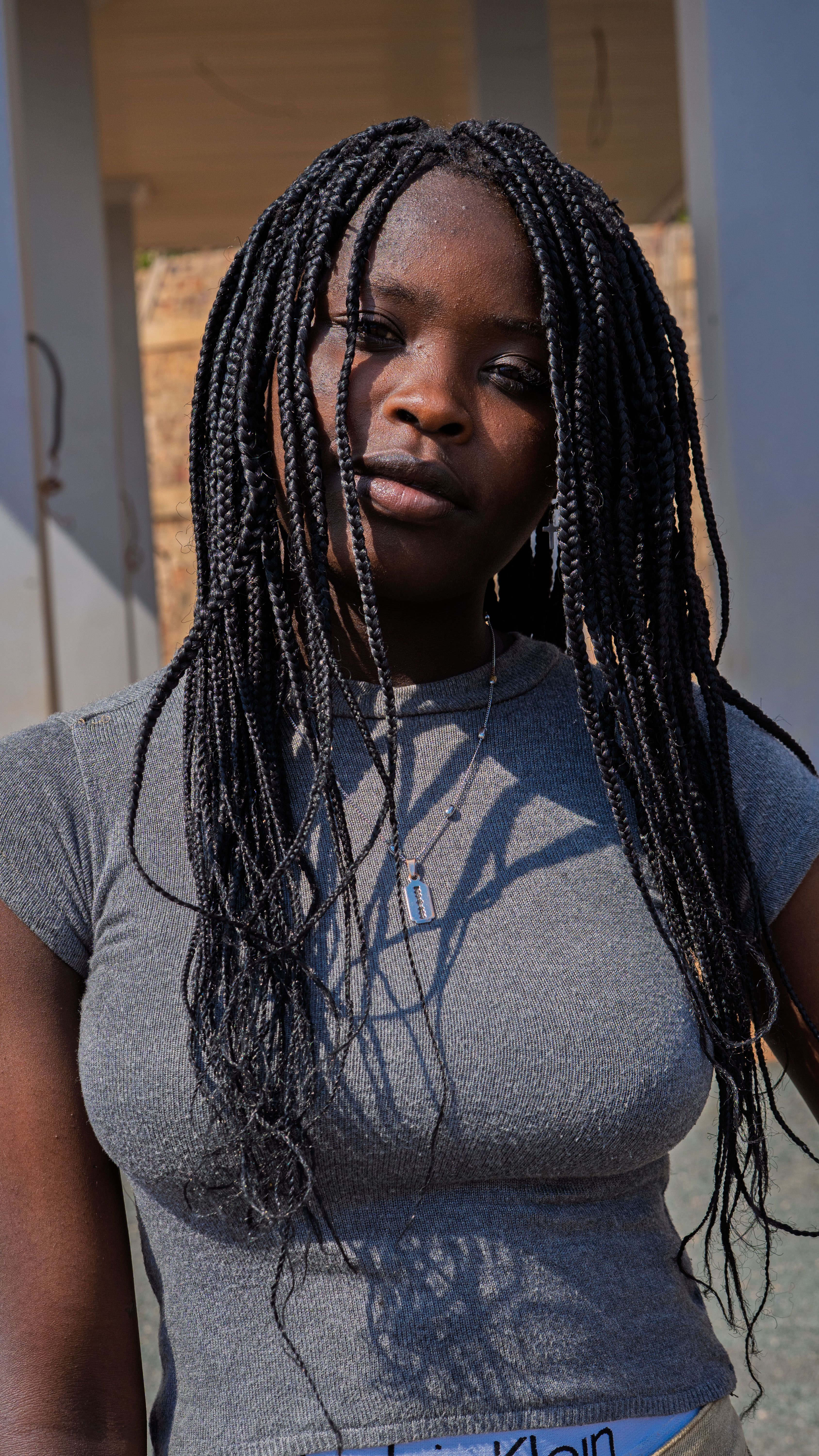 Portrait of a Young Woman with Braids · Free Stock Photo