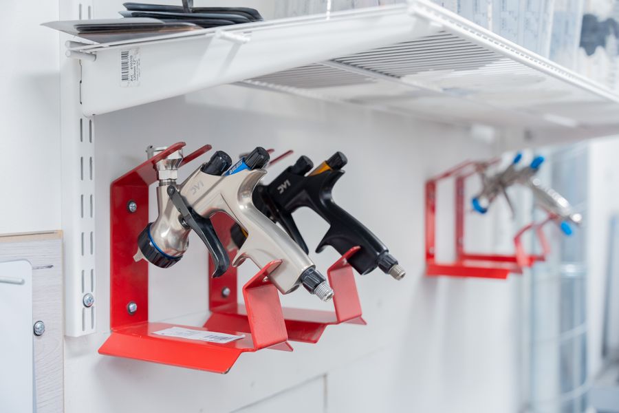 Professional pneumatic spray tools mounted in an automotive workshop