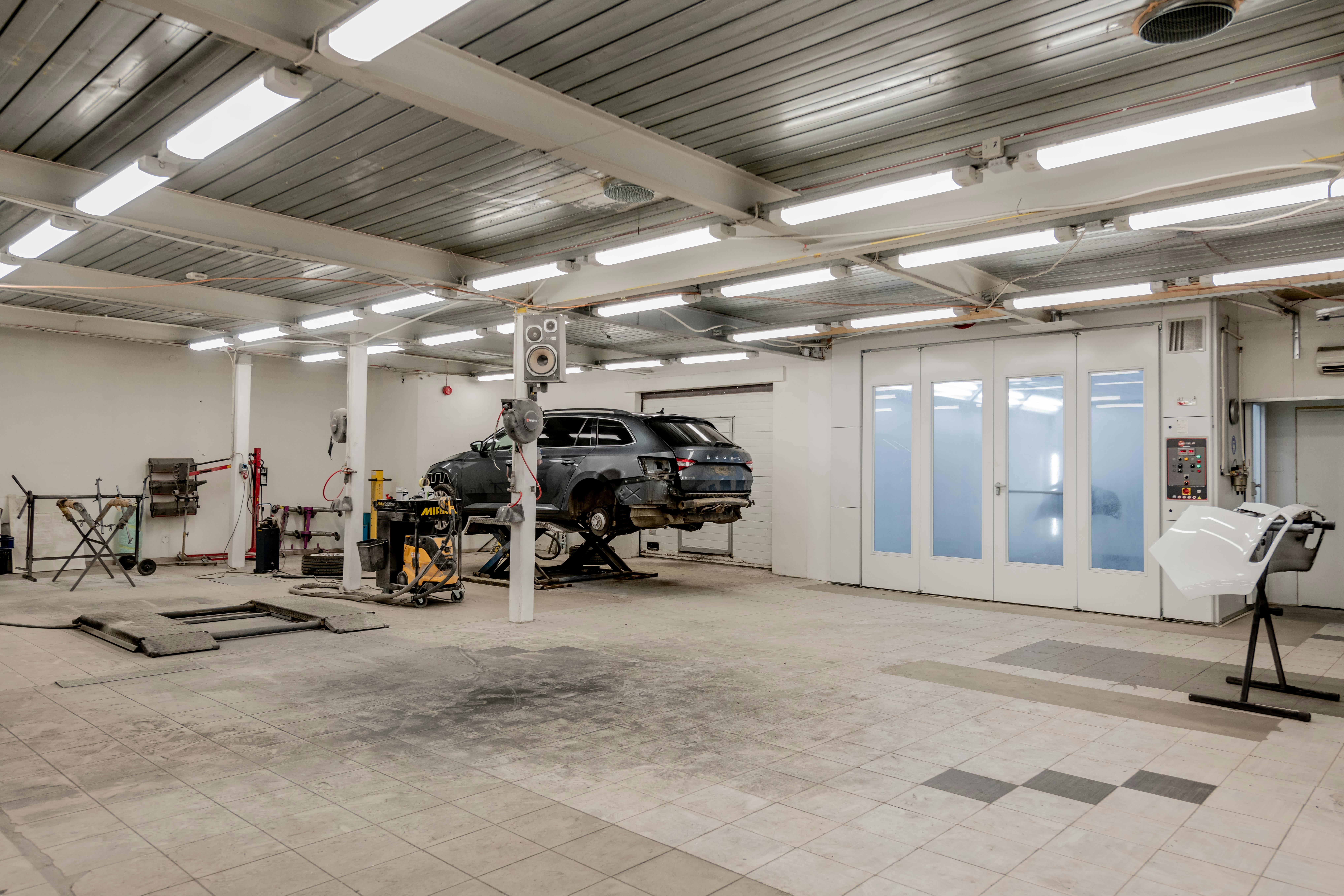 Autowerkes service bay with BMW on lift - bmw maintenance mileage interval