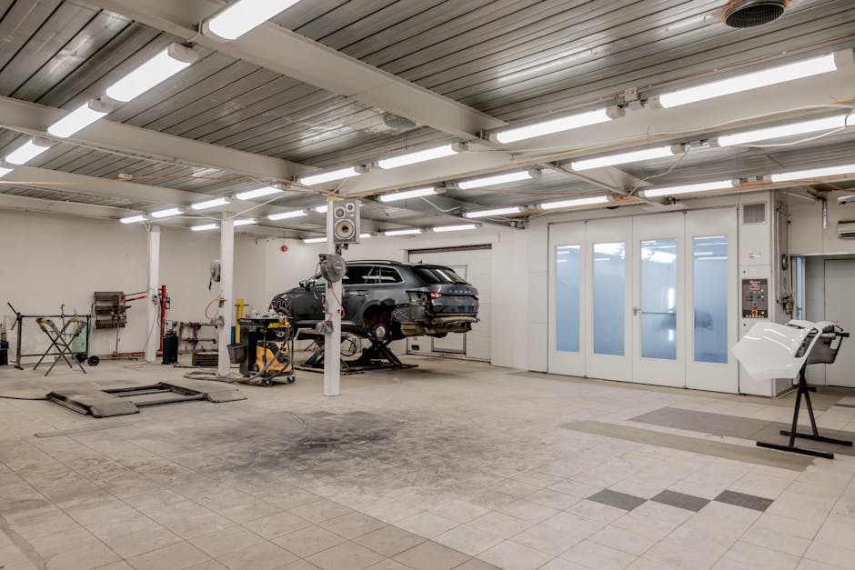 Autowerkes service bay with BMW on lift - bmw maintenance mileage interval Autowerkes service bay with BMW on lift - bmw maintenance mileage interval