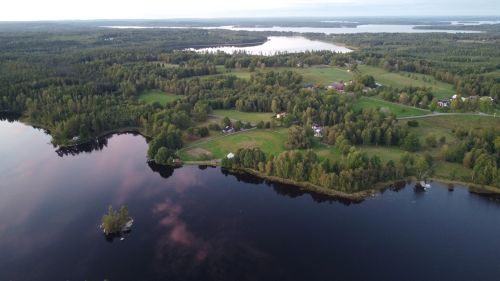 Free Stunning aerial view of lush Swedish countryside with serene lake and forest landscape. Stock Photo