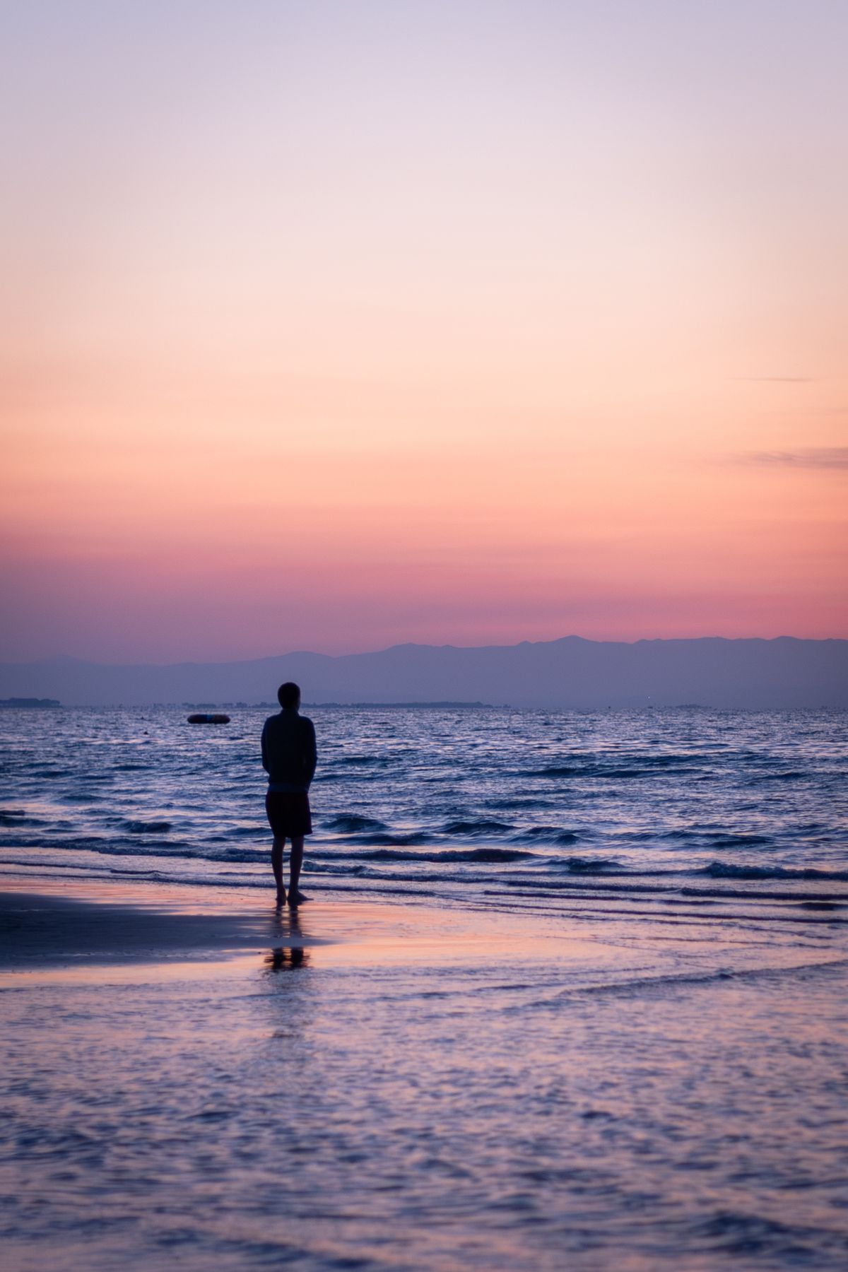 Silhouette of Man Standing on Beach during Sunset · Free Stock Photo