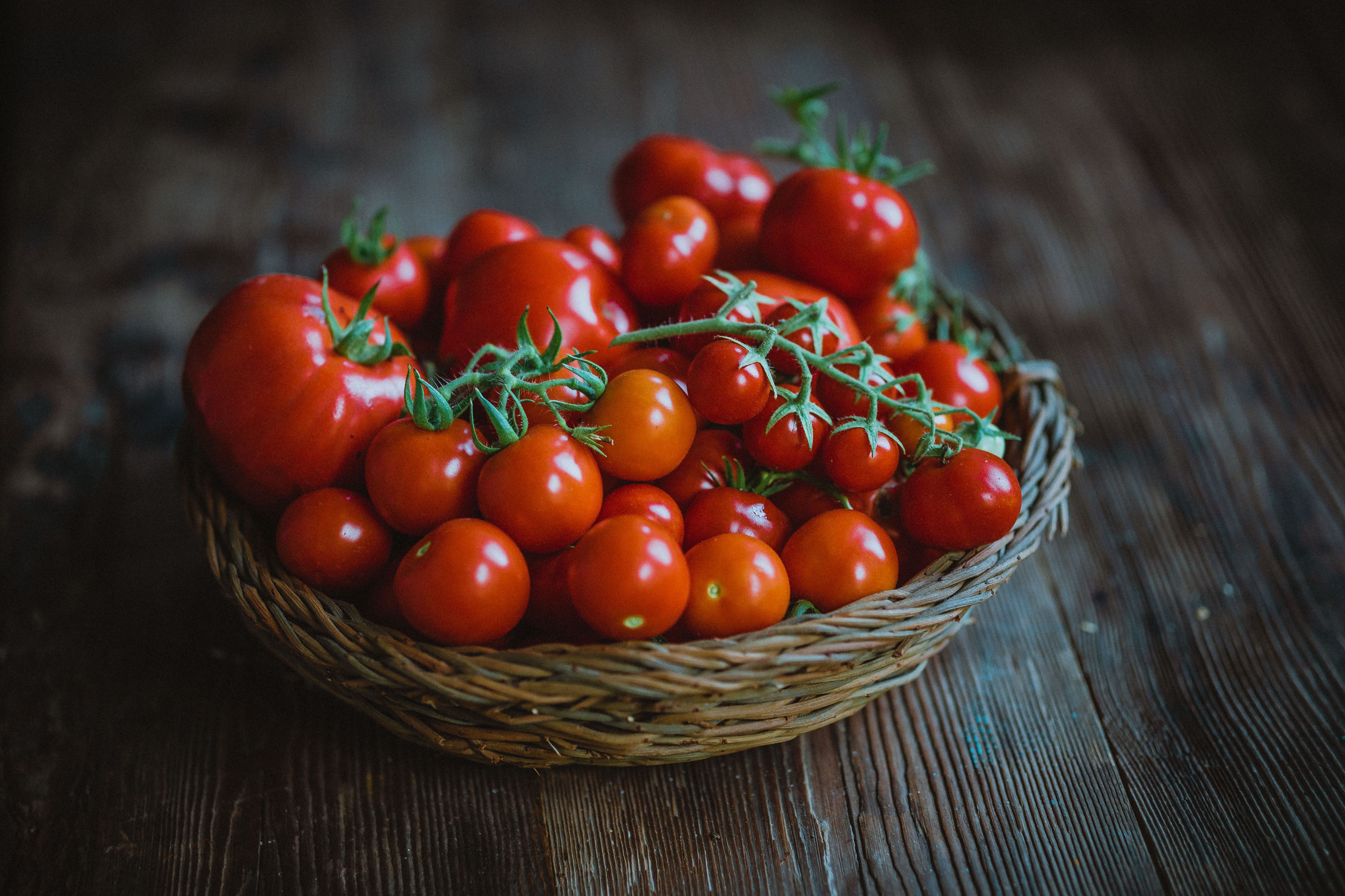 Basket of Fresh Red Tomatoes on Wooden Table · Free Stock Photo